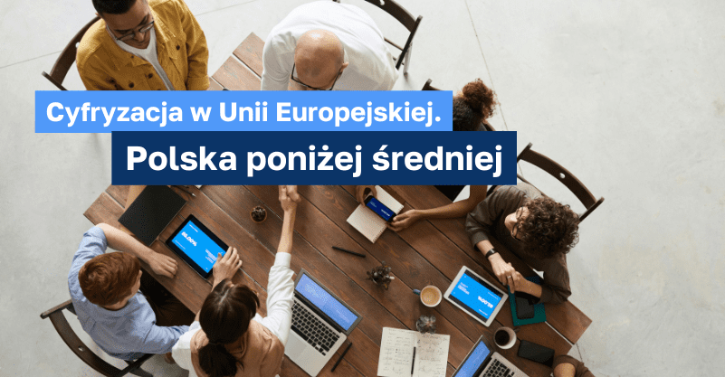 osoby siedzące przy stole z komputerami